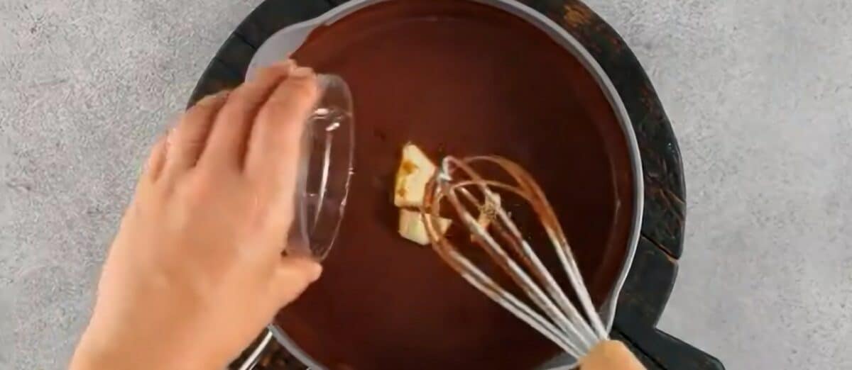 Adding butter and vanilla to the pudding.