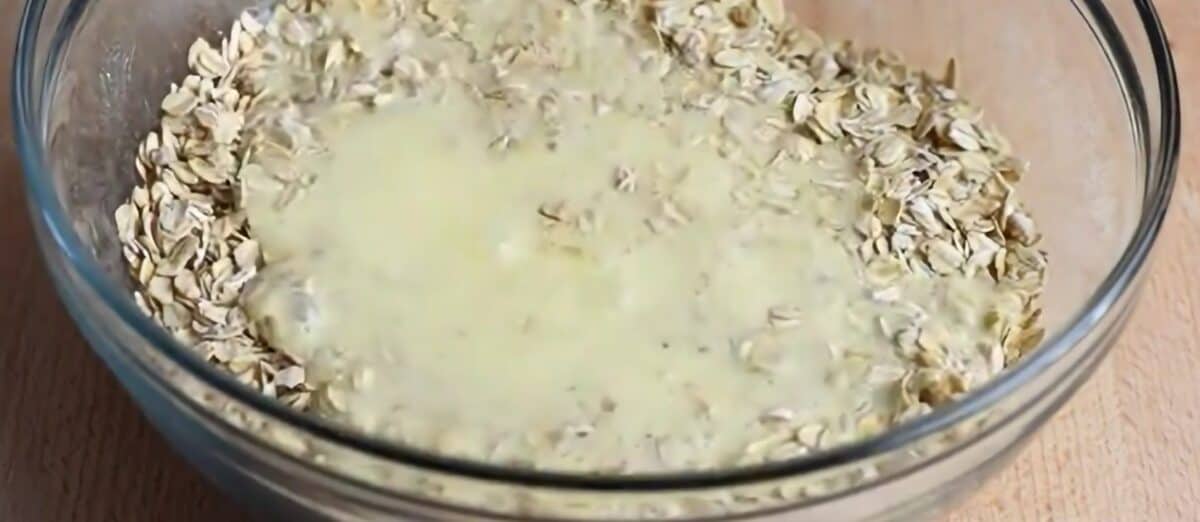 Pouring the wet ingredients over the dry ingredients.