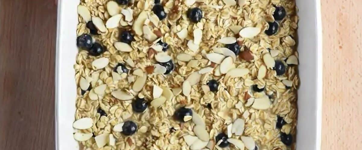 Baked oatmeal mixture in a white baking pan.