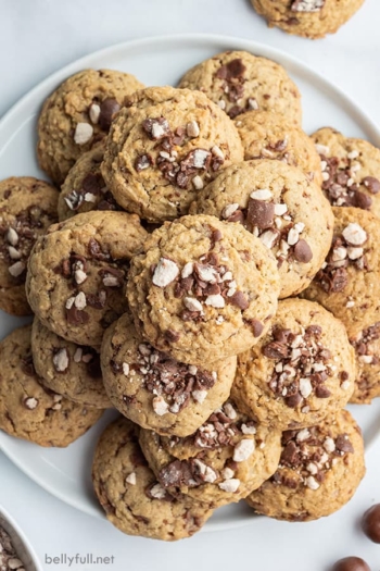 stack of chocolate malt ball cookies on white plate