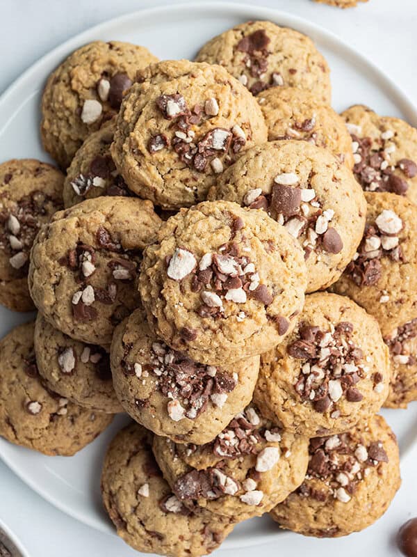 stack of chocolate malt ball cookies on white plate