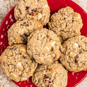 overhead of oatmeal craisin cookies piled on a red plate