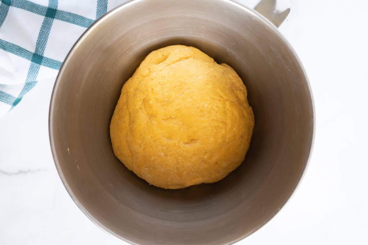 Proofed pumpkin cinnamon roll dough.
