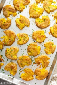 overhead of roasted smashed potatoes on baking sheet