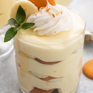layered banana pudding in parfait glass with whipped cream
