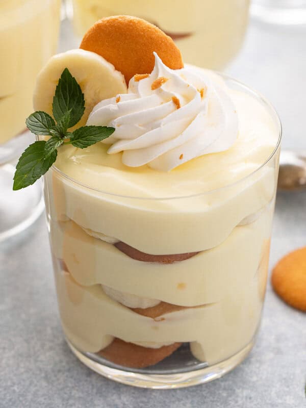 layered banana pudding in parfait glass with whipped cream