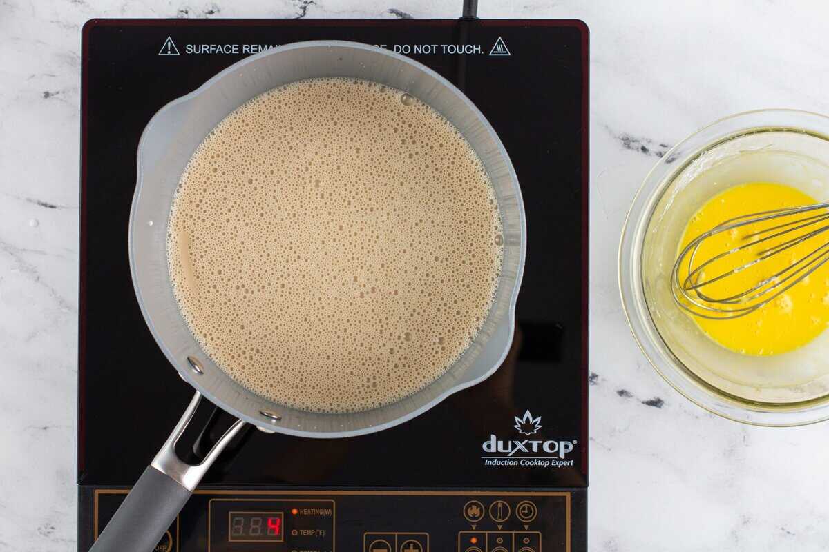 Adding the milk mixture to the pot with the brown sugar.