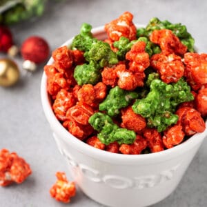 Christmas colored caramel popcorn in white popcorn canister