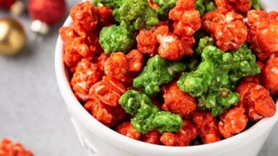 Christmas colored caramel popcorn in white popcorn canister