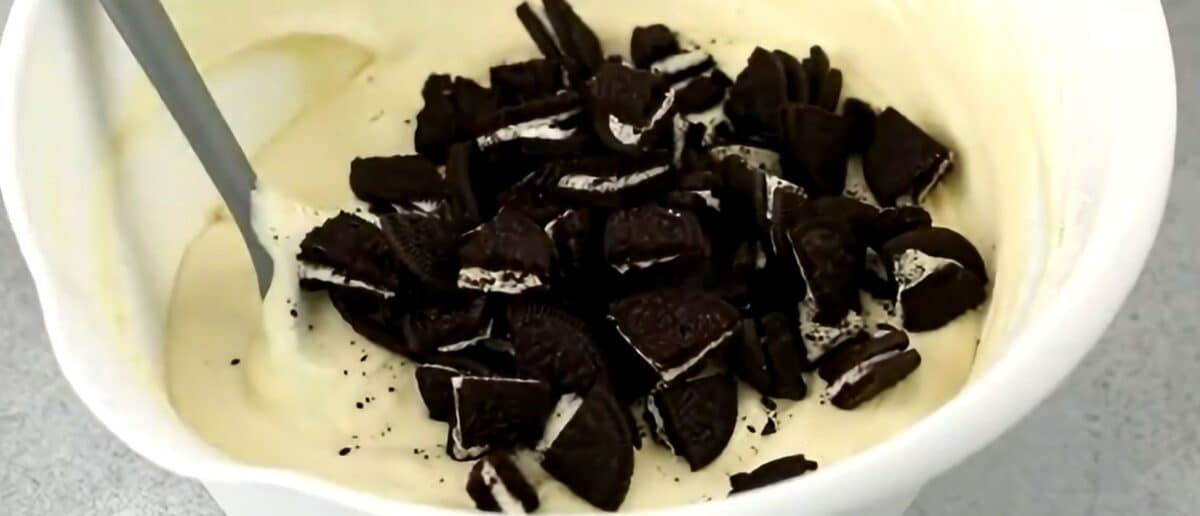 Folding quartered Oreo cookies into the filling.