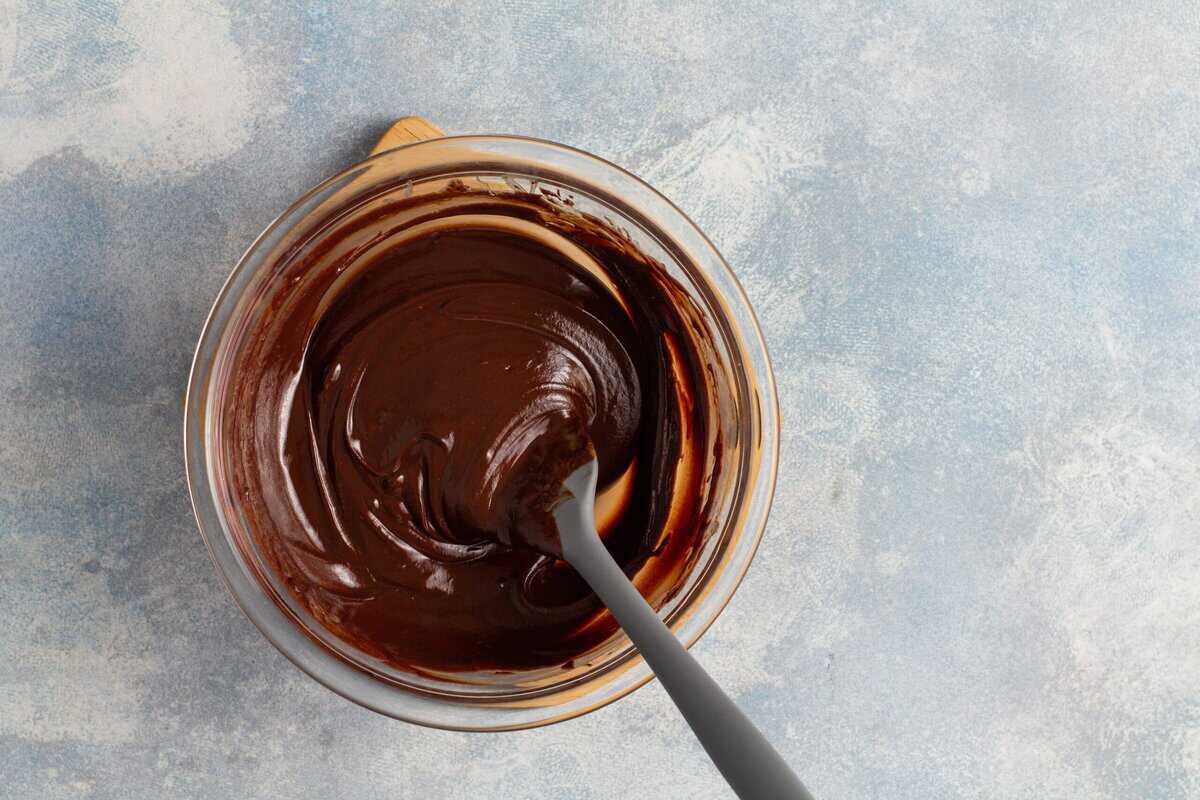Combining the melted chocolate and cream.