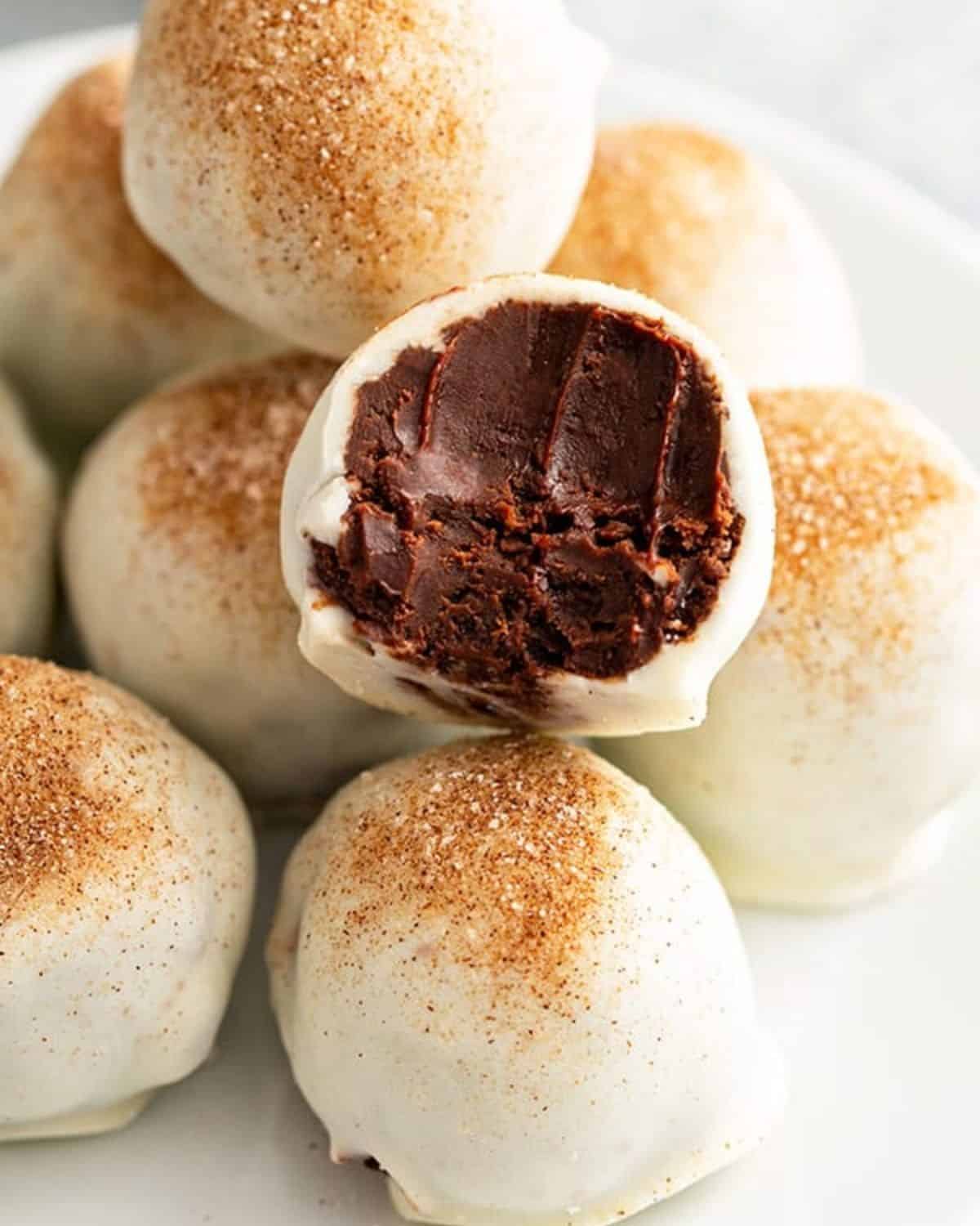 Bailey's chocolate truffles with a bite taken out of one.