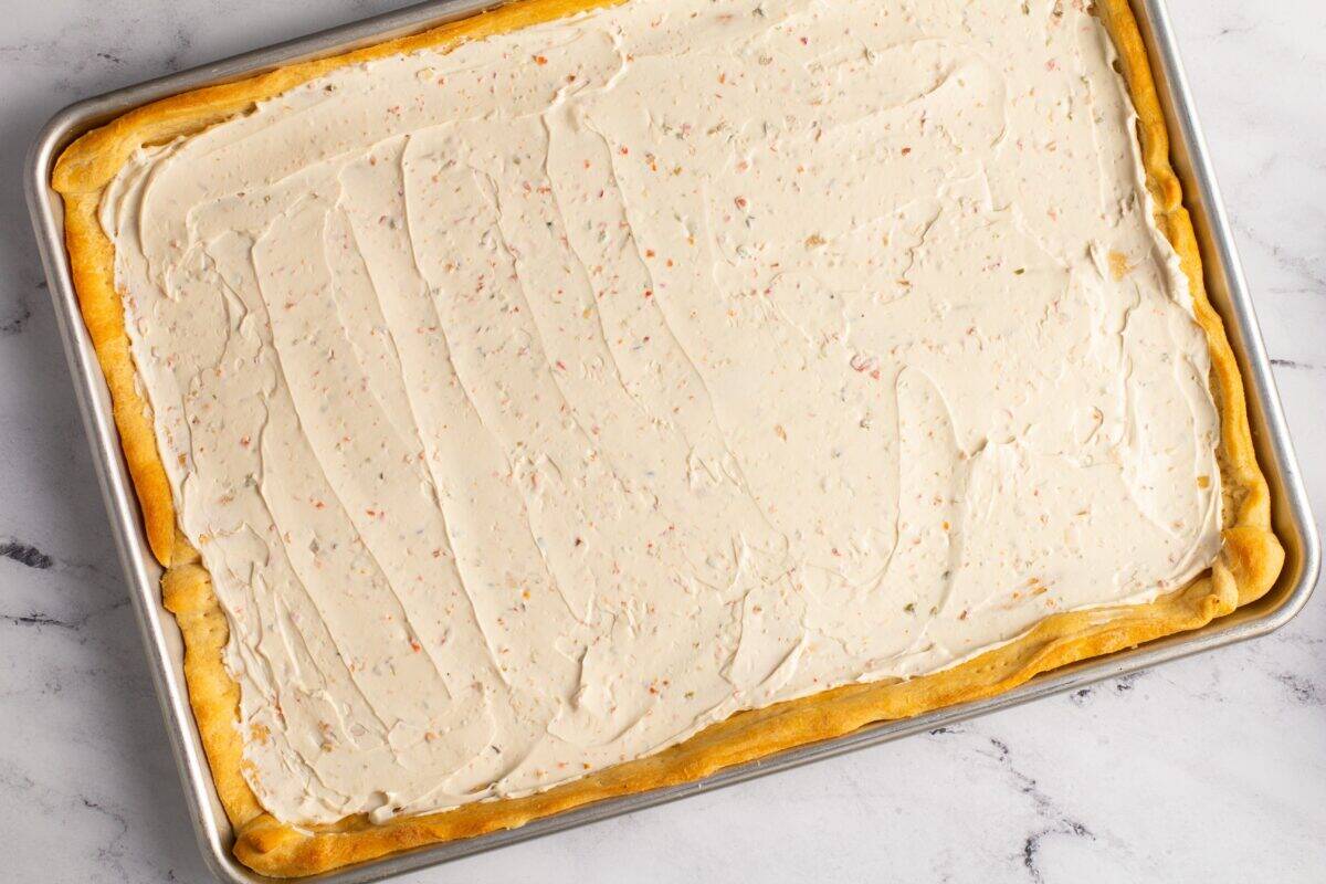 Pizza crust covered with cream cheese.