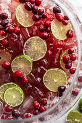 overhead close up of holiday punch garnished with cranberries and lime slices