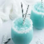 Jack Frost Winter Cocktail in glass with coconut flakes and straws