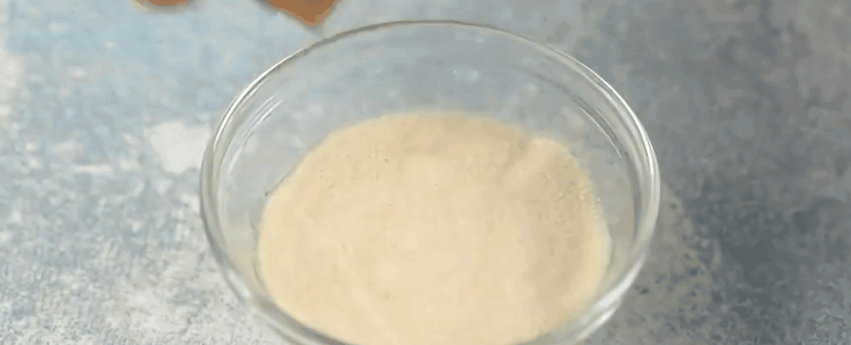 Gelatin powder and water in a small glass bowl.