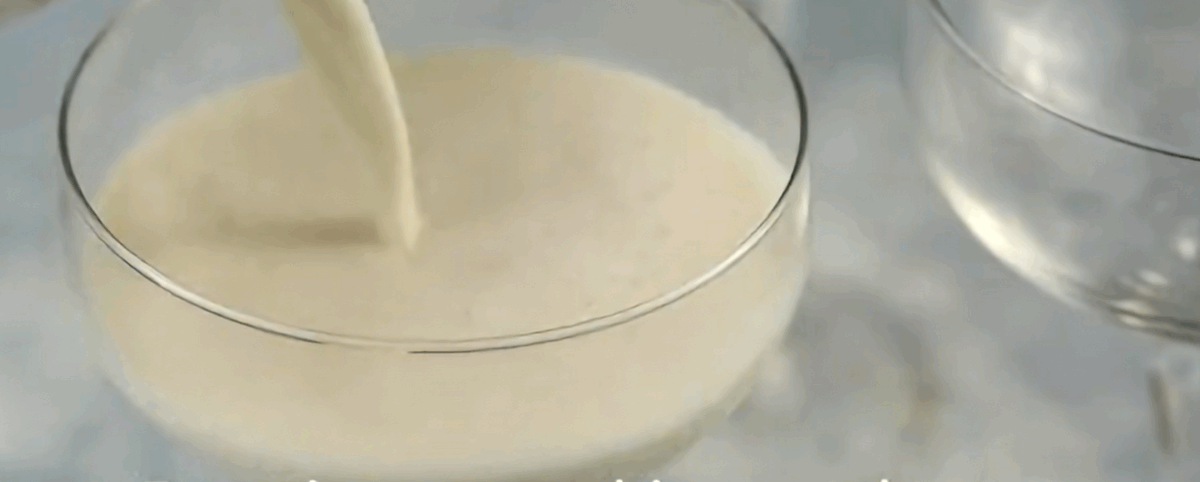 Pouring the panna cotta into glasses.