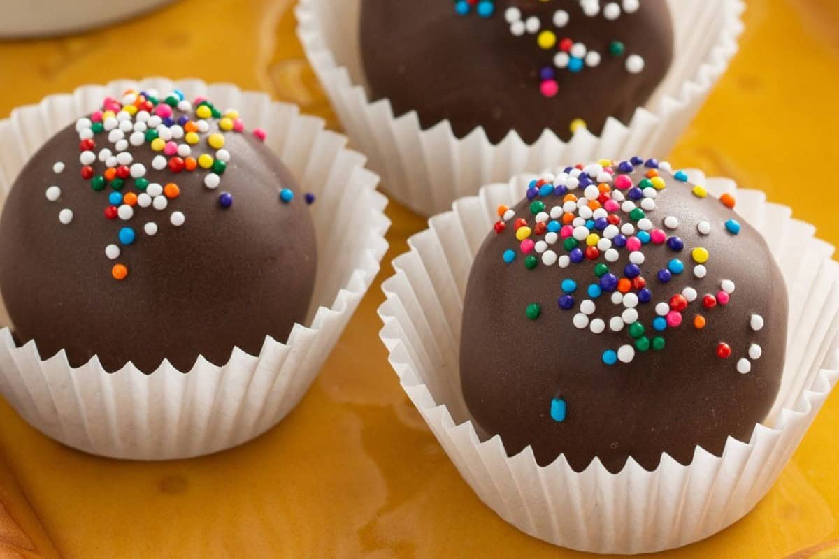 Truffles sitting in paper lines on a tray.
