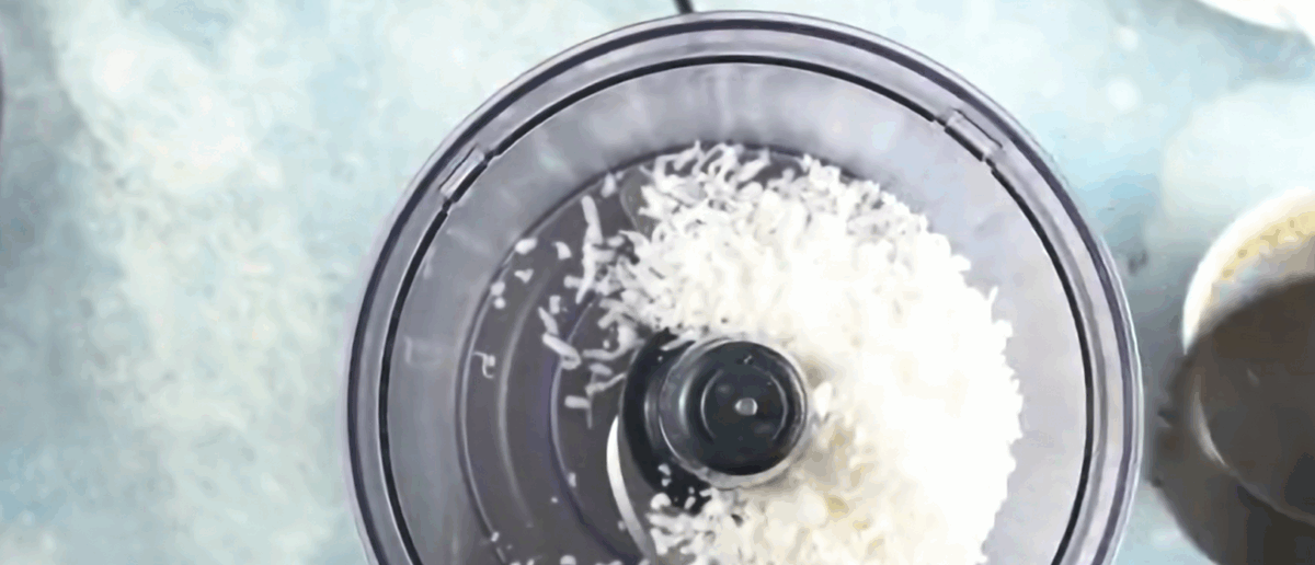 Processing coconut flakes and breadcrumbs in the food processor.
