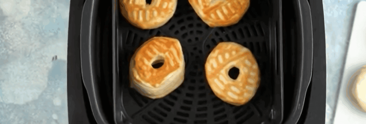 Golden air fryer donuts in the air fryer.