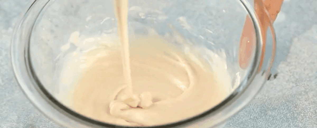 Making the glaze for the donuts in a glass bowl.