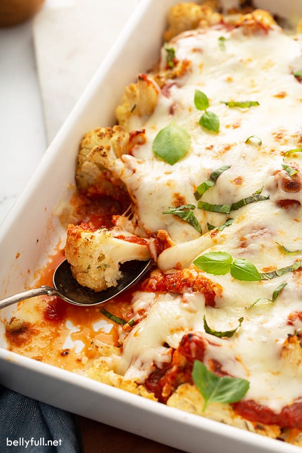 baked cauliflower with marinara sauce and cheese on spoon