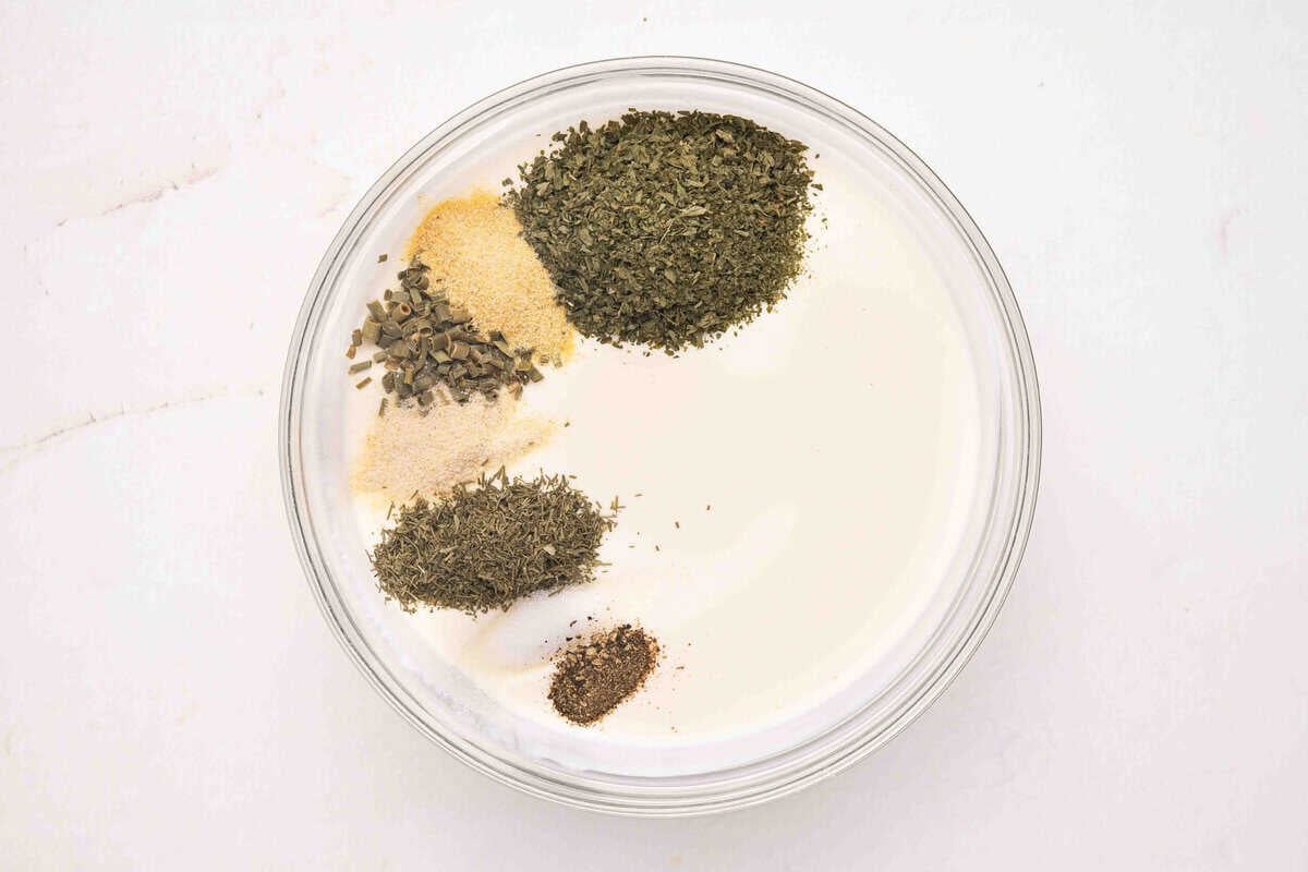 herbs and spices being added to make homemade ranch dressing