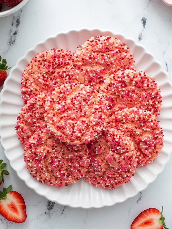 overhead of fanned strawberry cake mix cookies on white plate