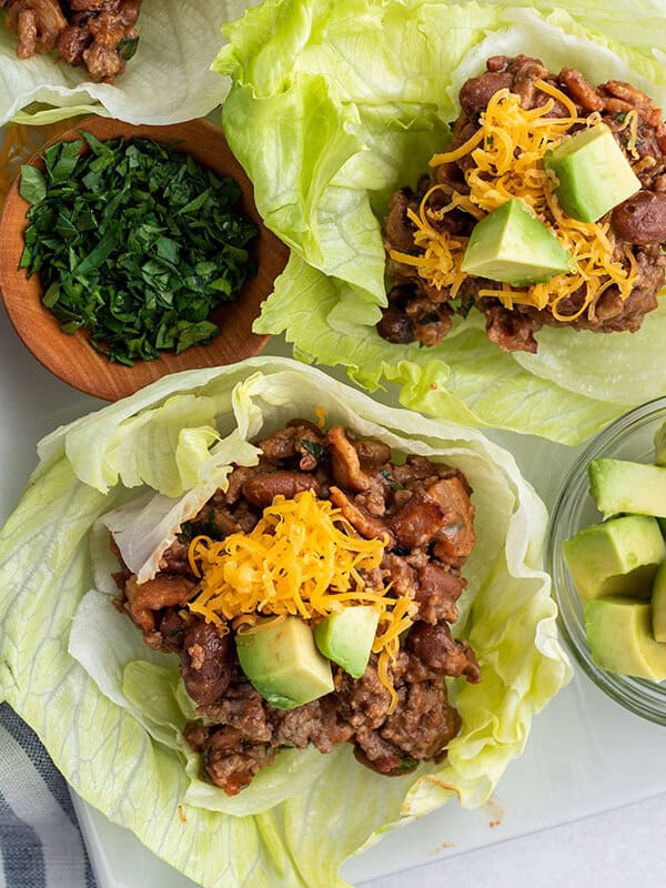 overhead of beef lettuce wrap with cheddar cheese and avocado