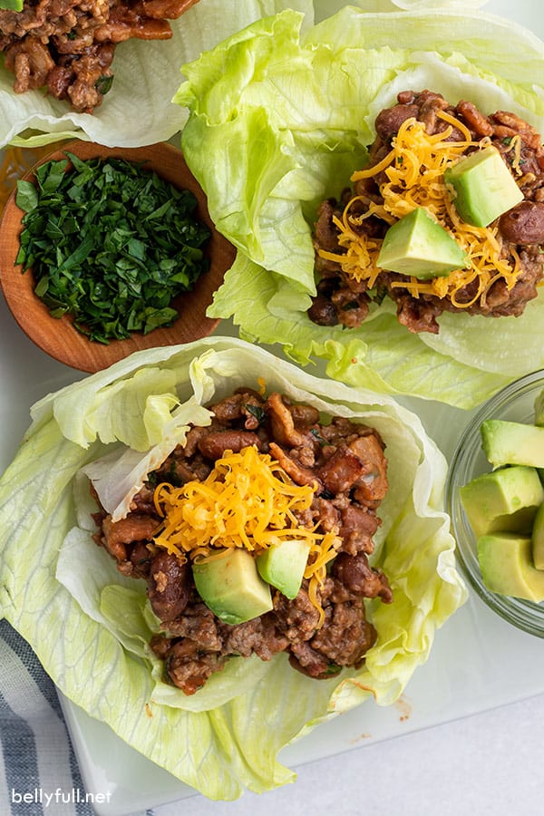 overhead of beef lettuce wrap with cheddar cheese and avocado