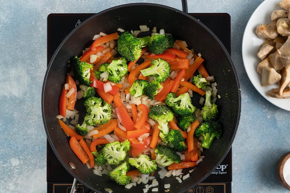 Cooking stir fry veggies in a skillet.