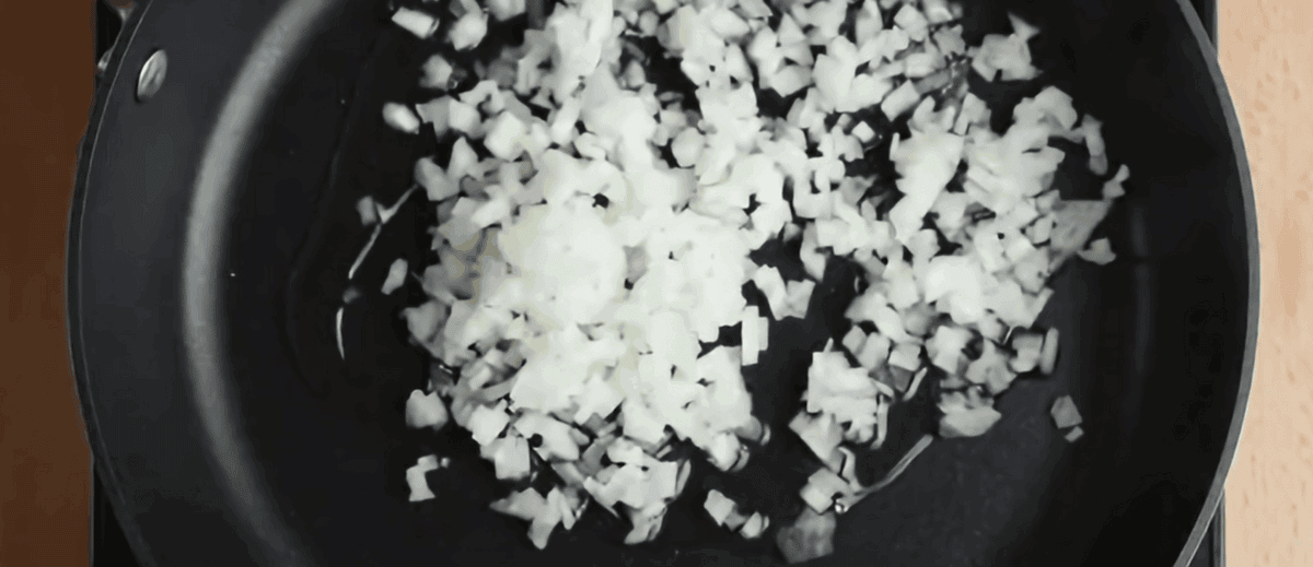 Cooking onions in a skillet.