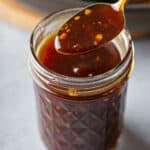 Stir Fry Sauce on spoon over mason jar