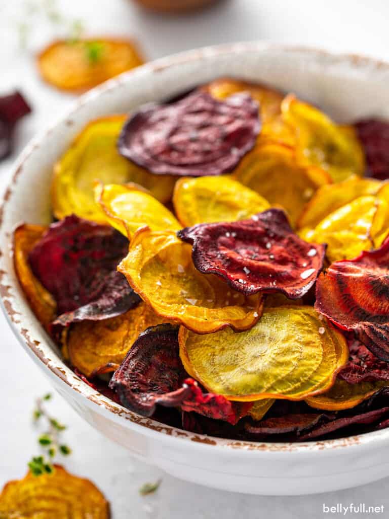 red and golden baked beet chips in bowl