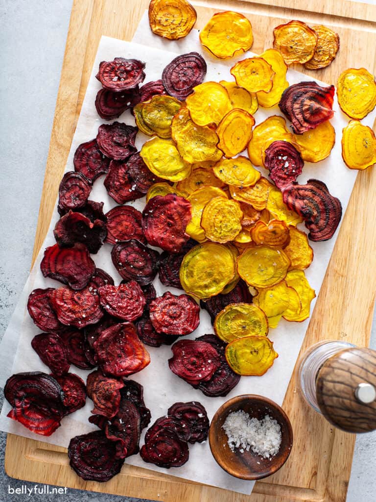 red and golden baked sliced beets on parchment paper