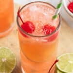 soda, crushed ice, and maraschino cherries in tall glass