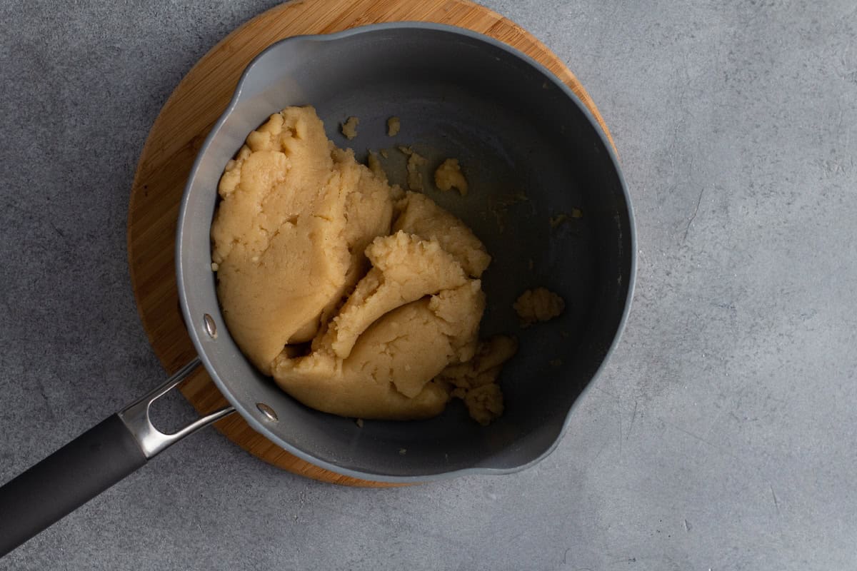 Wet churro dough in a saucepan.