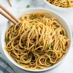 sesame noodles in bowl with chopsticks
