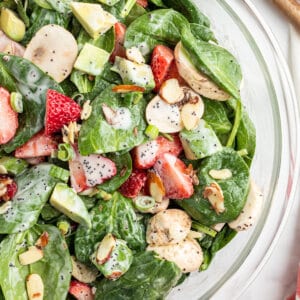 Strawberry Spinach Salad coated with poppy seed dressing close up