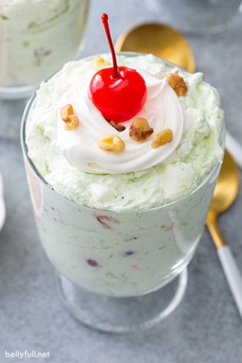 Watergate Salad parfait with whipped cream and a Maraschino cherry