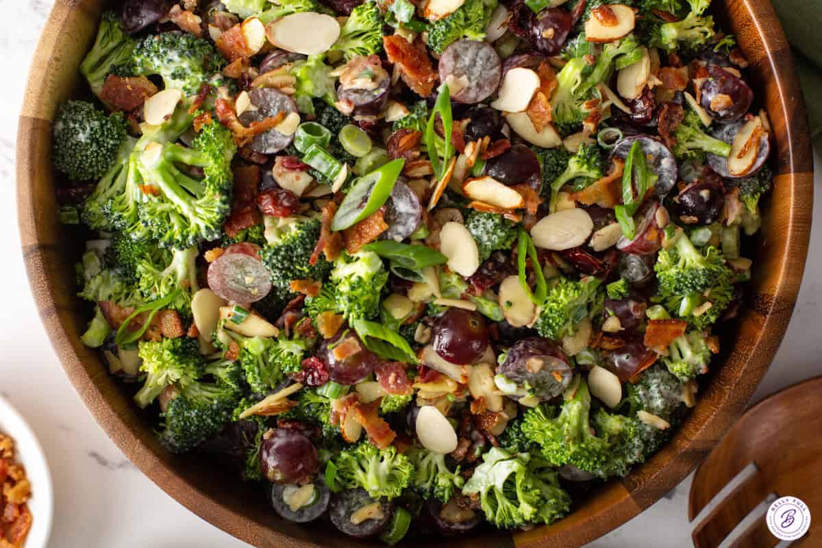 Assembled broccoli salad in a wooden bowl.