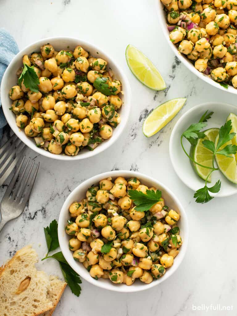 overhead of 2 white bowls filled with Garbanzo bean salad