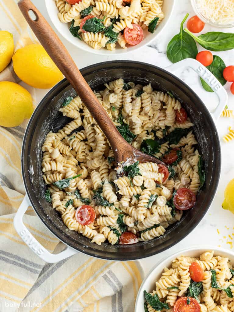 top down photo of lemon pasta in pot with wooden spoon