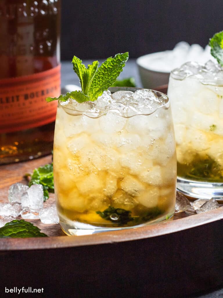 bourbon cocktail on on ice with mint sprig