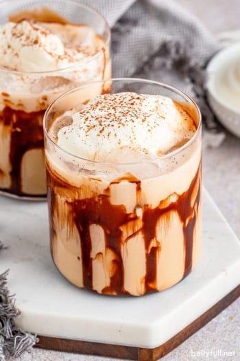 Mudslide cocktail garnished with whipped cream and cinnamon