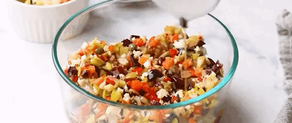 Olive salad in a glass container.