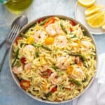 overhead of Orzo Salad with shrimp, asparagus, and tomatoes in serving bowl