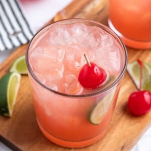 Sea Breeze Cocktail in high ball glass with cherry garnish