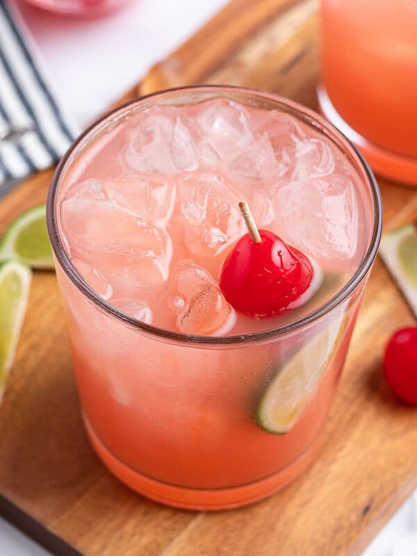 Sea Breeze Cocktail in high ball glass with cherry garnish