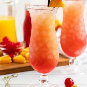 Sex on the Beach drink in hurricane glass with fruit garnish